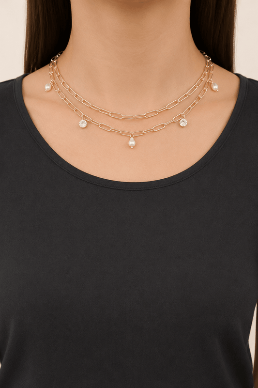 Pearl-effect and stone paperclip necklace worn on a fair-light skin model