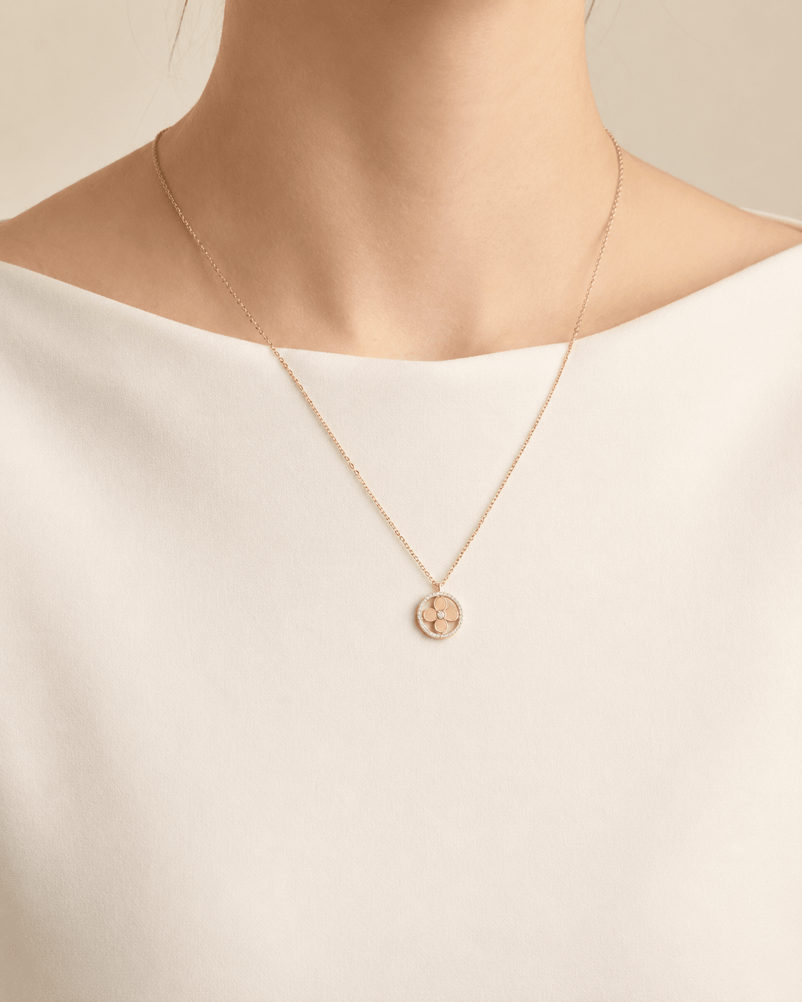 Jeweled clover pendant necklace worn on a fair-light skin model