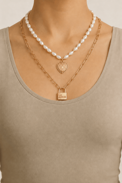 Pearl-effect heart and lock layered necklace worn on a fair-light skin model
