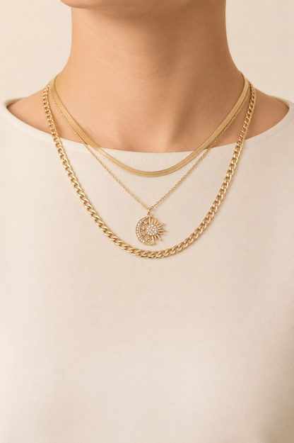 Sun and moon layered necklace worn on a fair-light skin model