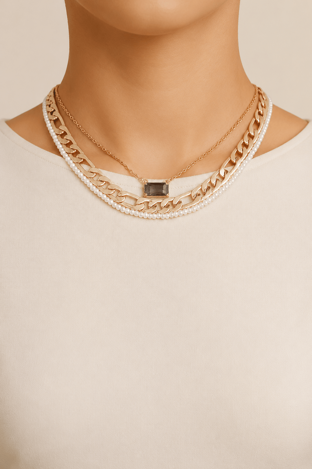 Jeweled and pearl-effect layered necklace worn on a fair-light skin model