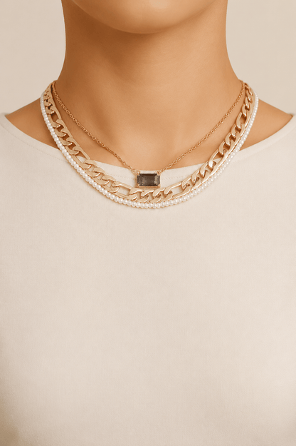 Jeweled and pearl-effect layered necklace worn on a fair-light skin model