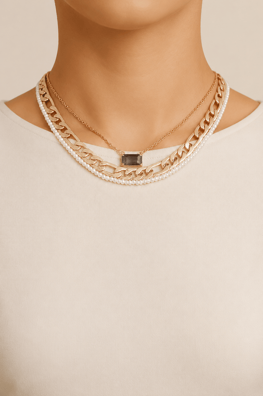 Jeweled and pearl-effect layered necklace worn on a fair-light skin model